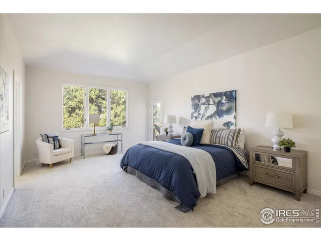 a spacious bedroom with a bed and a couch