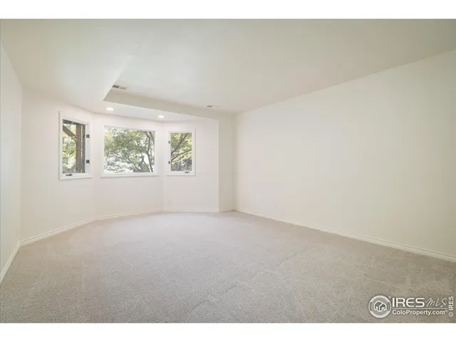 a bedroom with a large bed and a potted plant