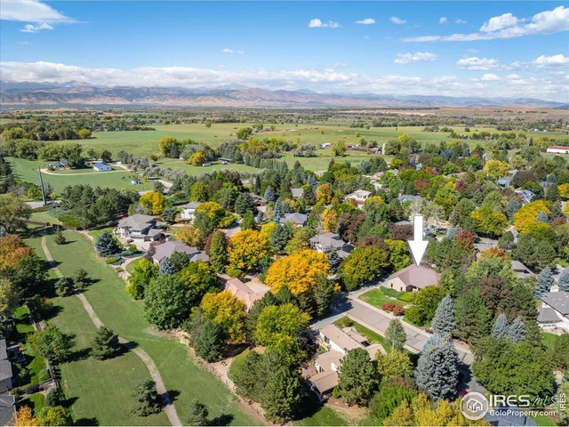 an aerial view of a house with a yard and garden
