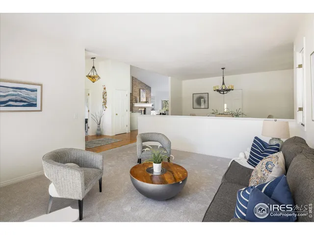 a living room with furniture and a mirror