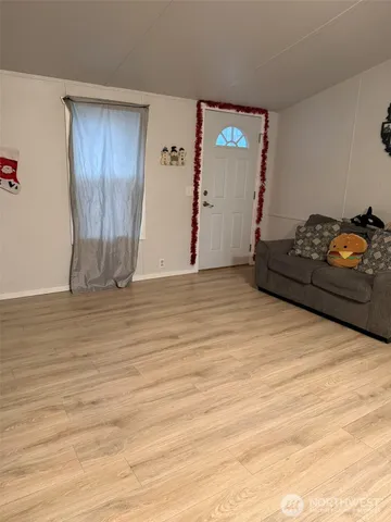 a living room with hard wood floors and a wooden floor