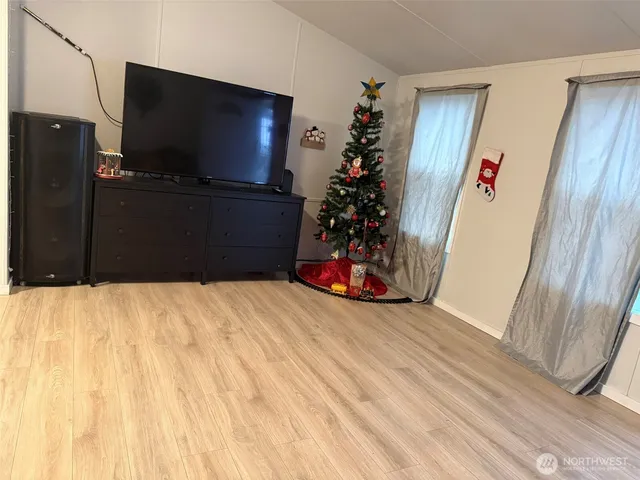 a view of a livingroom with furniture and an empty room