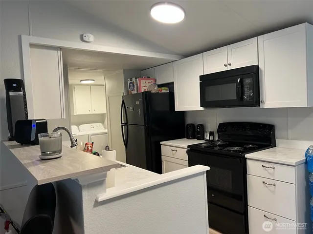 a kitchen with a sink a stove and refrigerator