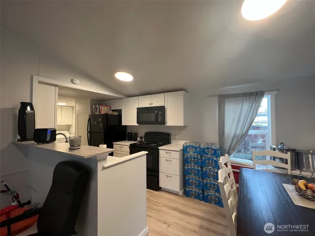 a view of a dining room with furniture and wooden floor
