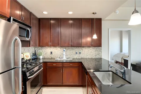 a bathroom with a double vanity sink toilet mirror and shower