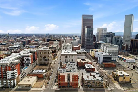 a bathroom with a granite countertop sink a toilet and a mirror