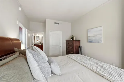 a living room with furniture a wooden floor and a potted plant