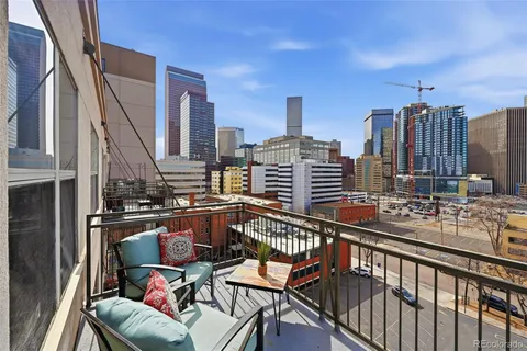 a kitchen with sink refrigerator and wooden floor