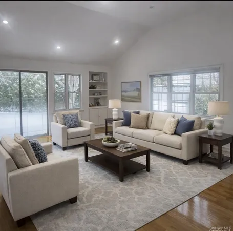 an empty room with wooden floor cabinet and windows