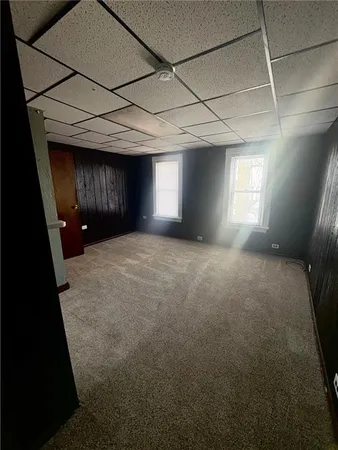 a view of a room with a fireplace and window