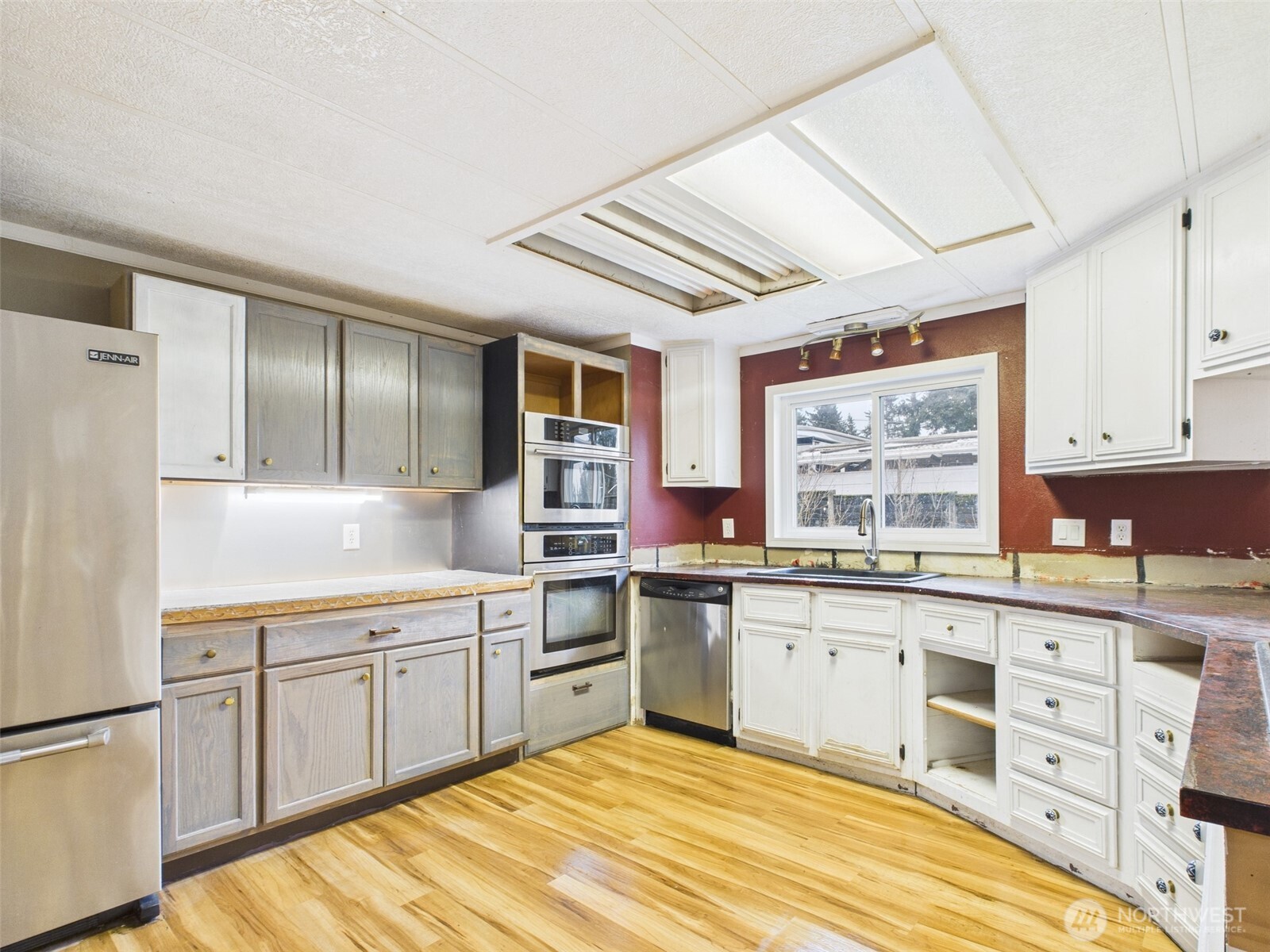 201 Union Avenue Southeast, Unit 183 Renton, WA 98059 - Photo 11 of 30 a kitchen with stainless steel appliances granite countertop a sink cabinets and wooden floor