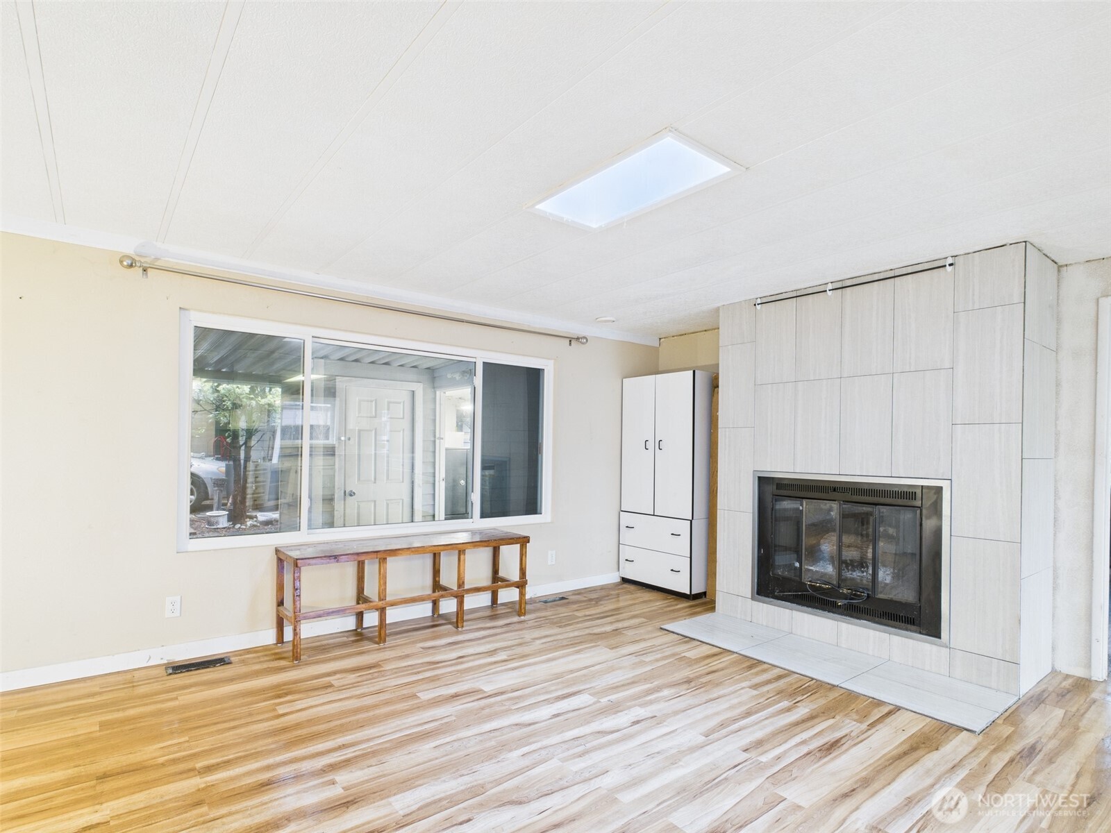 201 Union Avenue Southeast, Unit 183 Renton, WA 98059 - Photo 16 of 30 a view of an empty room with wooden floor fireplace and a window