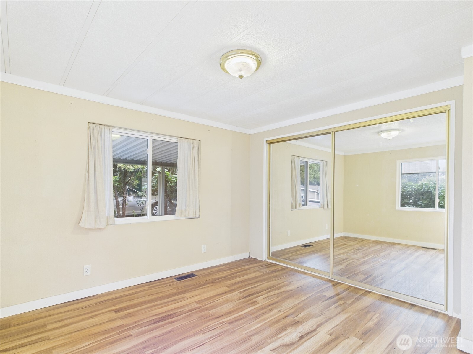 201 Union Avenue Southeast, Unit 183 Renton, WA 98059 - Photo 18 of 30 a view of an empty room with wooden floor and a window