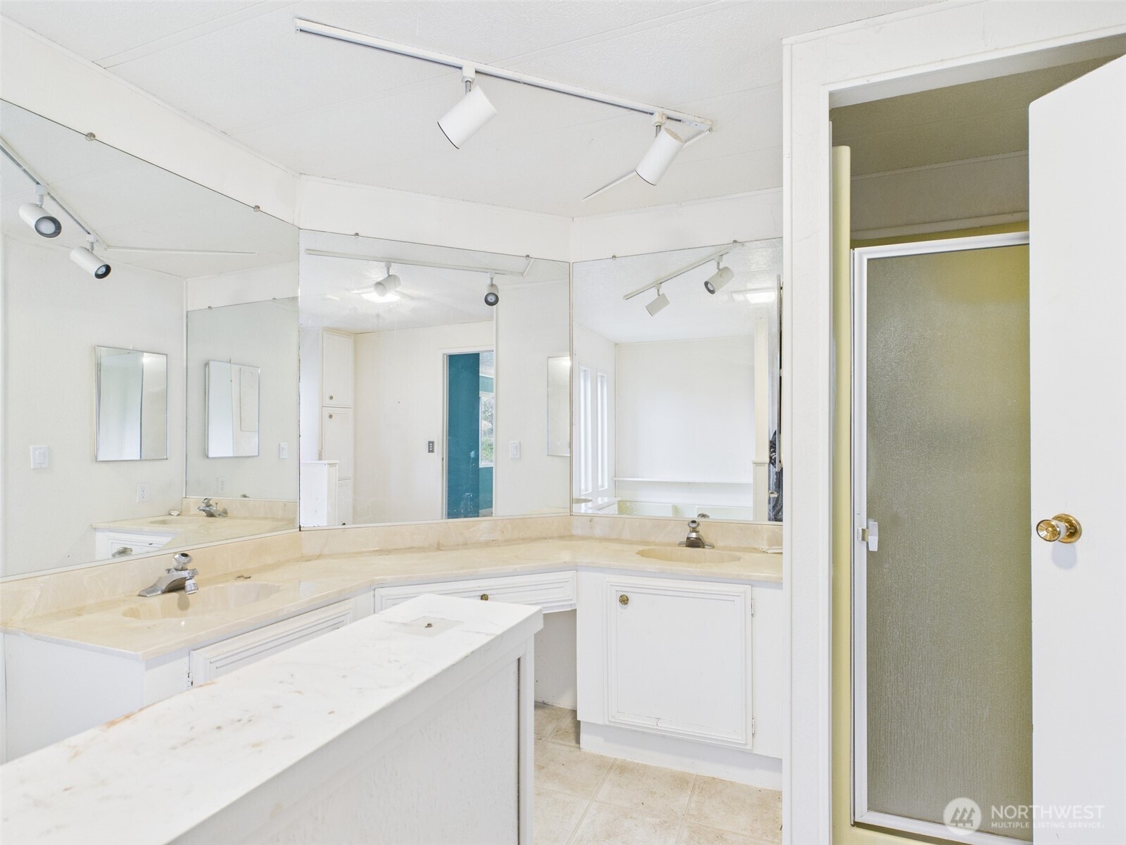 201 Union Avenue Southeast, Unit 183 Renton, WA 98059 - Photo 21 of 30 a bathroom with a sink a large mirror and a shower