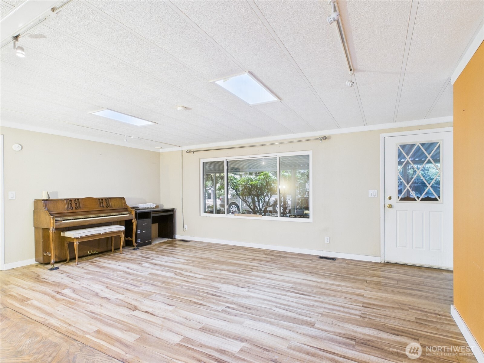 201 Union Avenue Southeast, Unit 183 Renton, WA 98059 - Photo 5 of 30 a view of a livingroom with furniture a flat screen tv and wooden floor