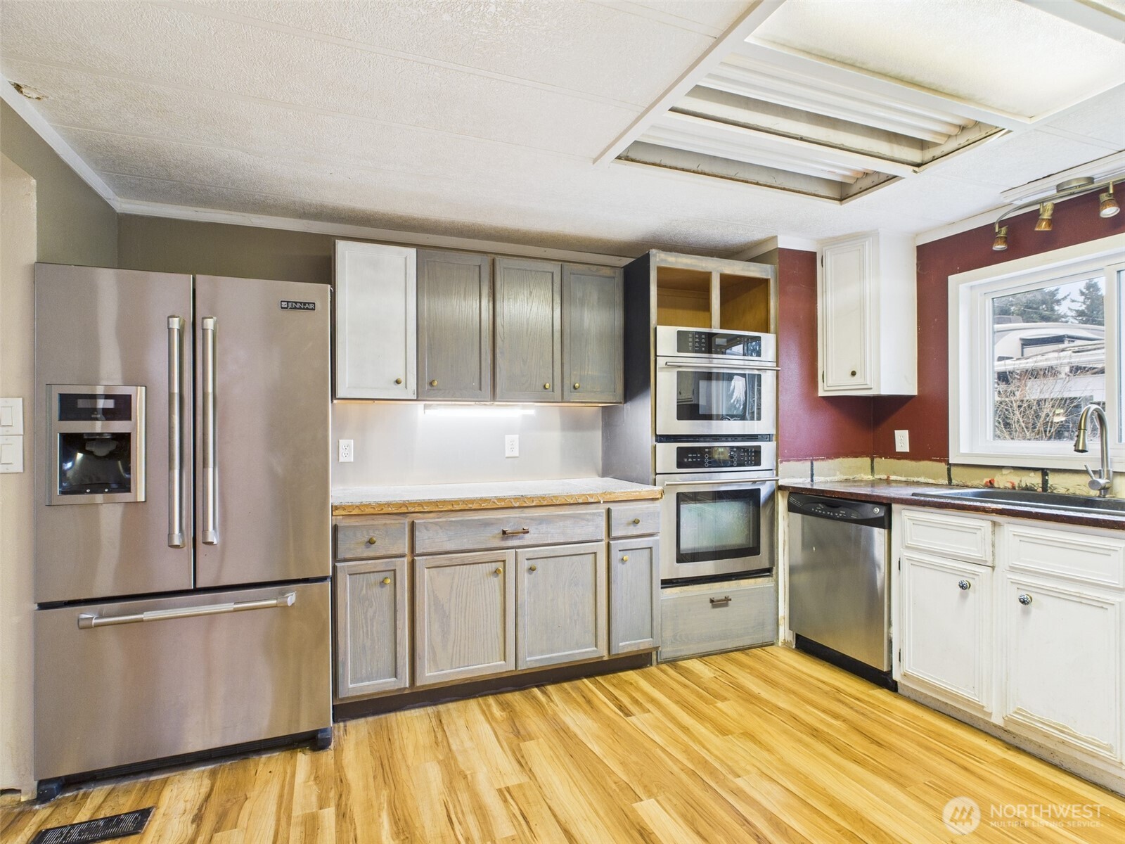 201 Union Avenue Southeast, Unit 183 Renton, WA 98059 - Photo 10 of 30 a kitchen with granite countertop stainless steel appliances a sink and cabinets