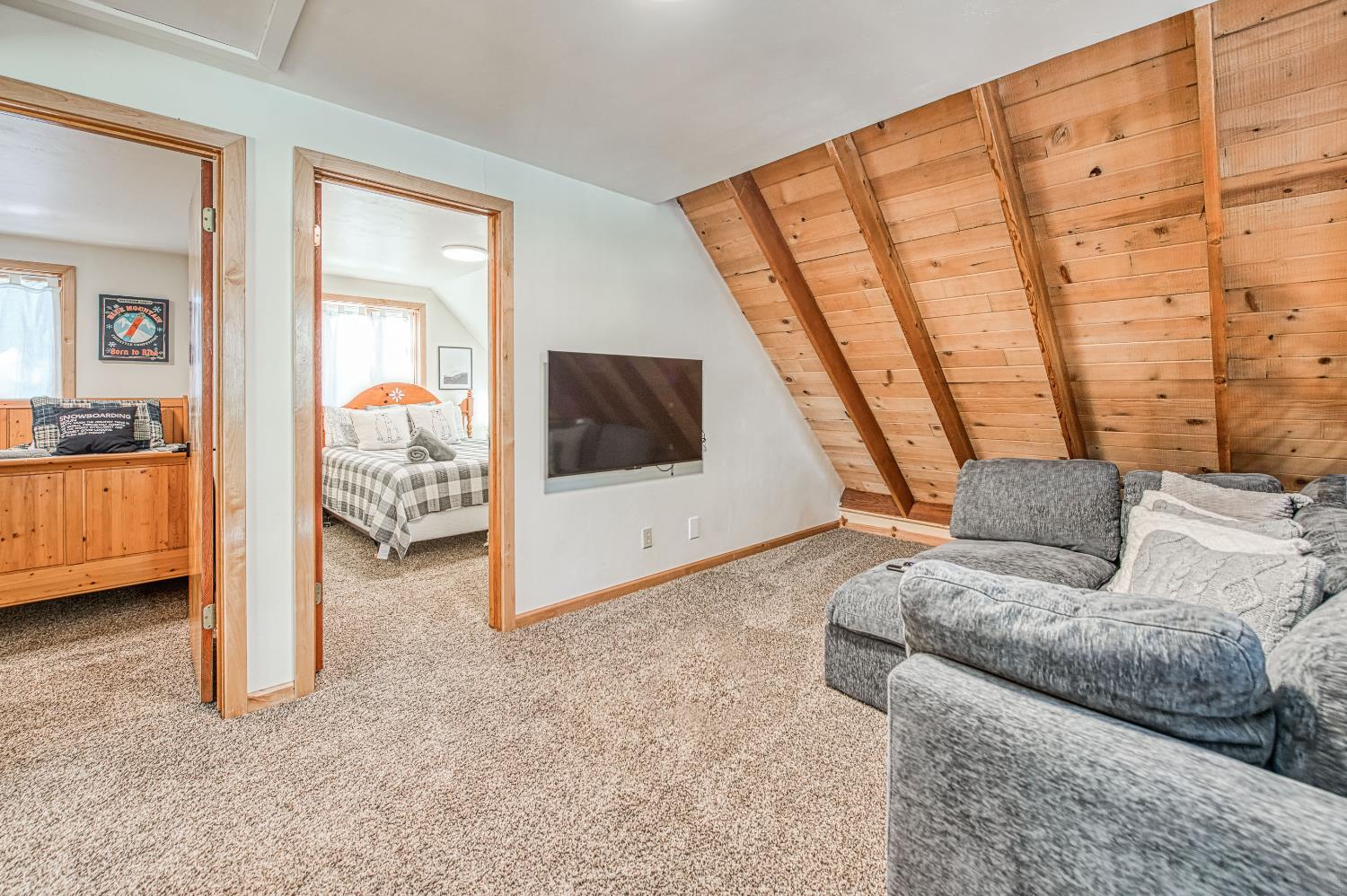 55578 Cordwood Road Shaver Lake, CA 93664 - Photo 24 of 59 a living room with furniture and a flat screen tv