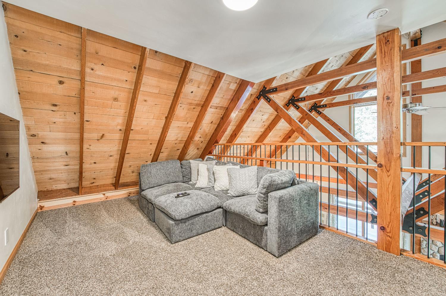 55578 Cordwood Road Shaver Lake, CA 93664 - Photo 25 of 59 a living room with furniture a rug and white walls