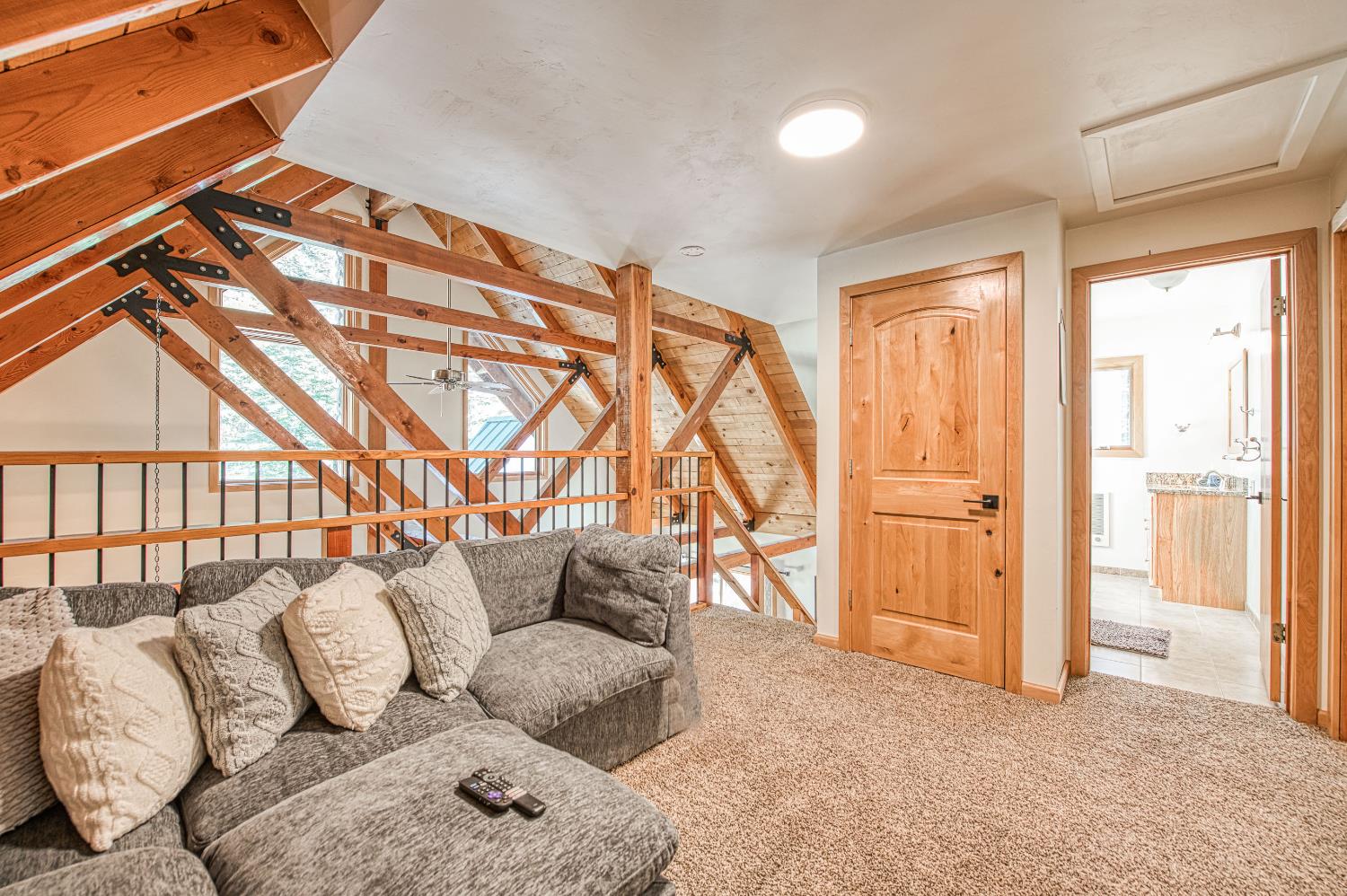55578 Cordwood Road Shaver Lake, CA 93664 - Photo 26 of 59 a balcony with furniture and a rug