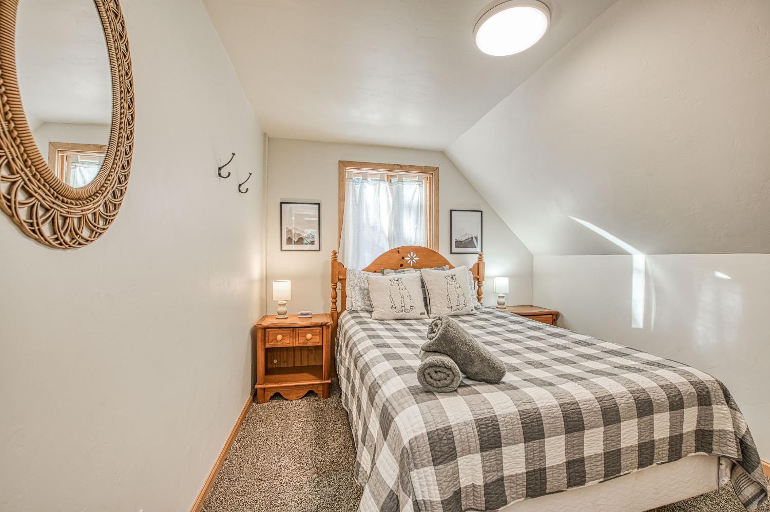 55578 Cordwood Road Shaver Lake, CA 93664 - Photo 30 of 59 a bedroom with a bed and a chandelier