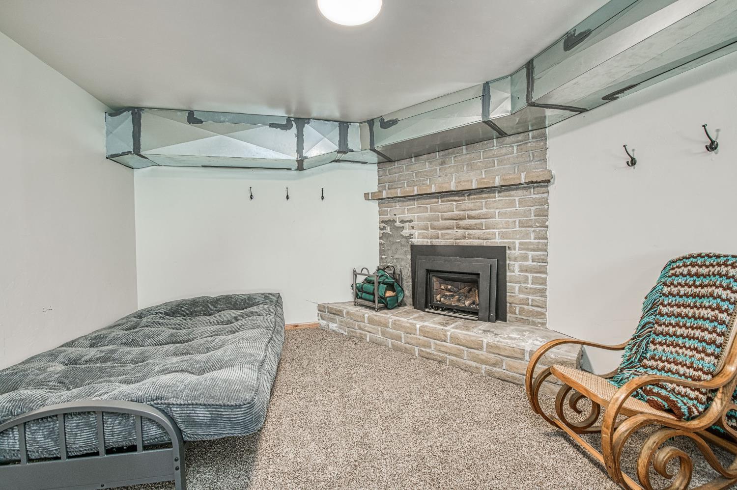 55578 Cordwood Road Shaver Lake, CA 93664 - Photo 36 of 59 a living room with furniture and a fireplace