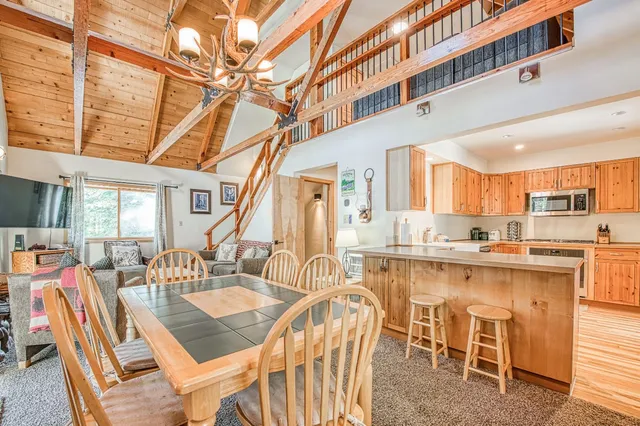 a dinning area with a table chairs and a kitchen view