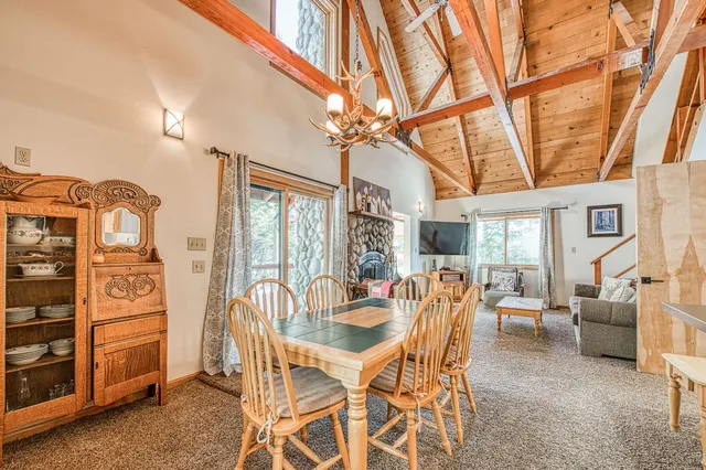 a dining room with furniture water view and large windows