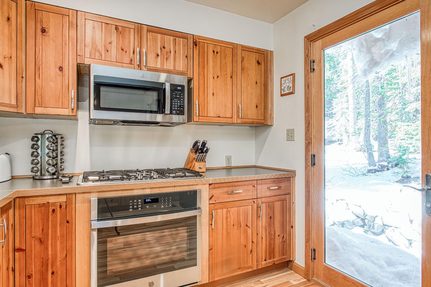 55578 Cordwood Road Shaver Lake, CA 93664 - Photo 8 of 59 a kitchen with stainless steel appliances granite countertop a stove a sink and a microwave