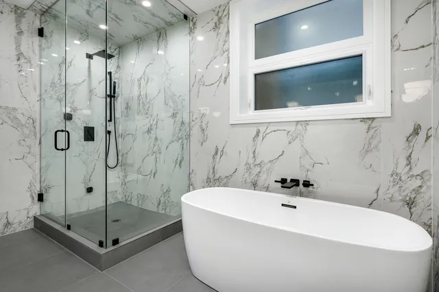 a bathroom with a bathtub and a shower