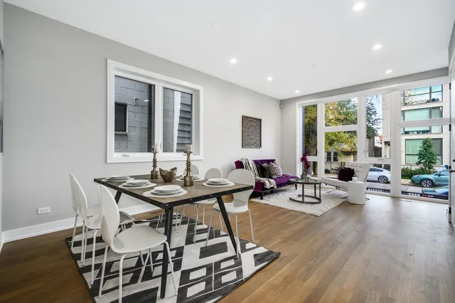 a view of a livingroom with furniture and floor to ceiling window