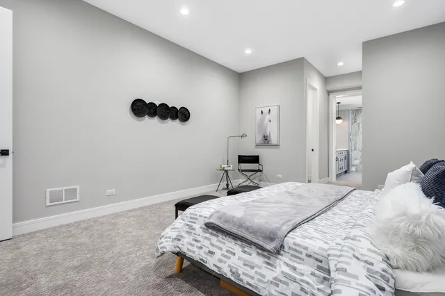 a bedroom with a bed and a mirror