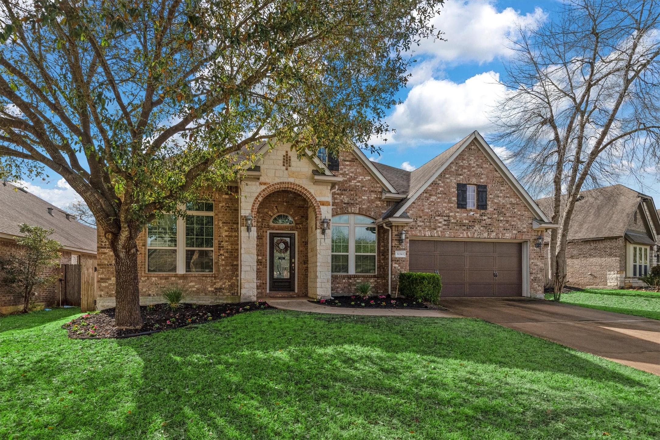 31563 Ember Trail Lane Spring, TX 77386 - Photo 2 of 39 The main level features a large, well-appointed kitchen, a cozy living area, a formal living/dining area, a home office, 3 secondary bedrooms and a private primary suite with a luxurious en-suite bathroom. There's also a 3 car tandem garage- space is not an issue in this home. There's plenty.