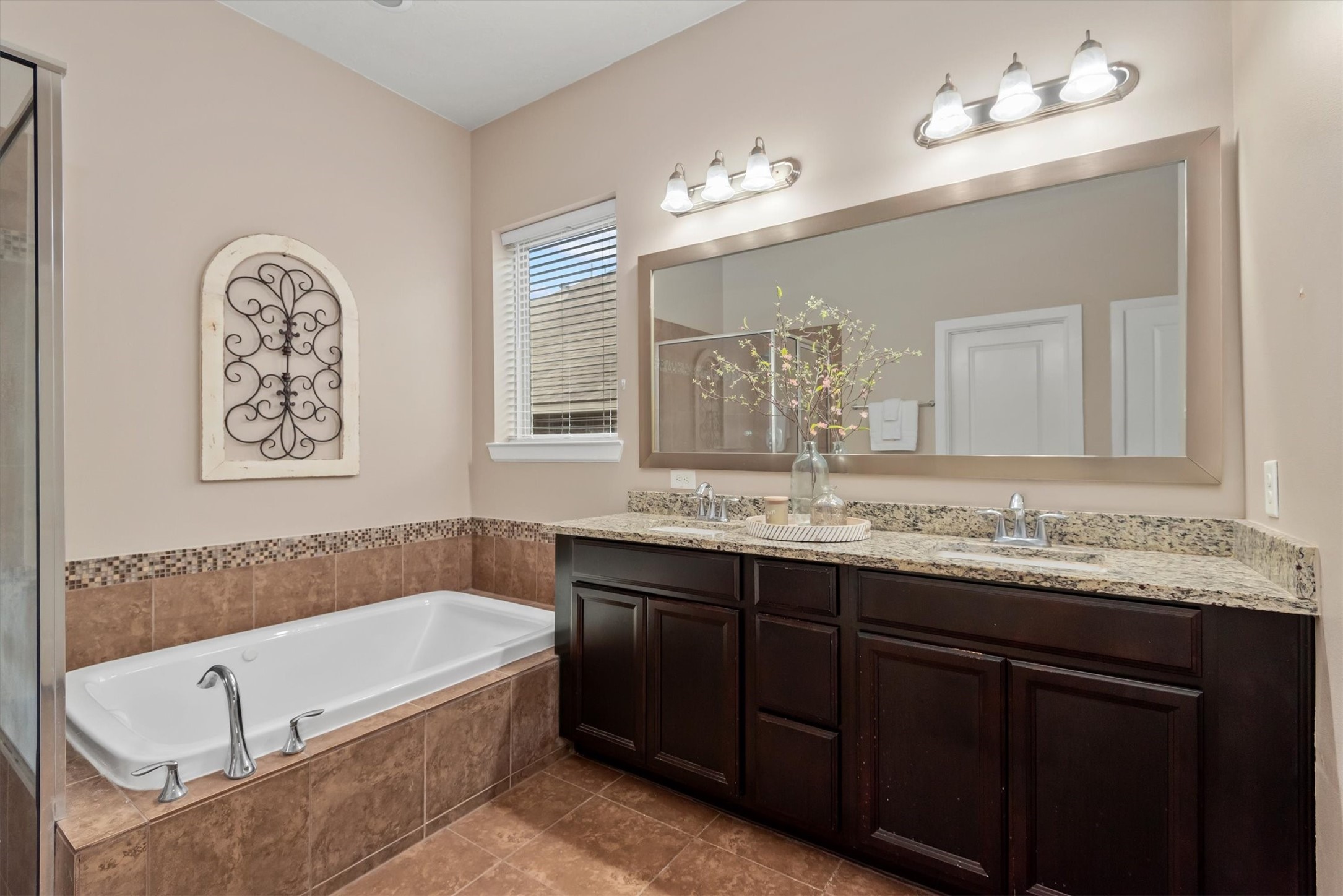 31563 Ember Trail Lane Spring, TX 77386 - Photo 22 of 39 a bathroom with a granite countertop bathtub a sink and a mirror