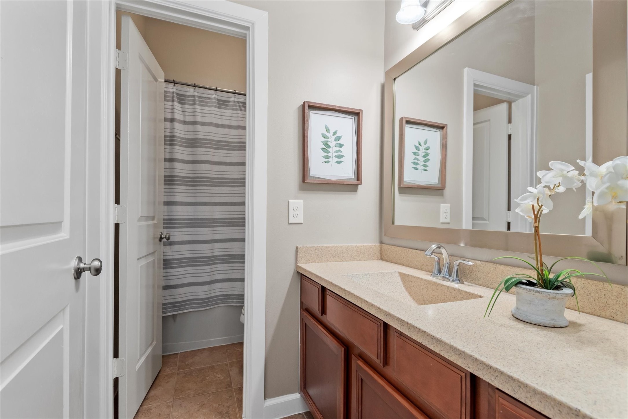 31563 Ember Trail Lane Spring, TX 77386 - Photo 27 of 39 The downstairs secondary bathroom offers both style and functionality. Designed with convenience in mind, it features a dual-access layout with a separate shower and toilet area, allowing multiple users to get ready with ease.