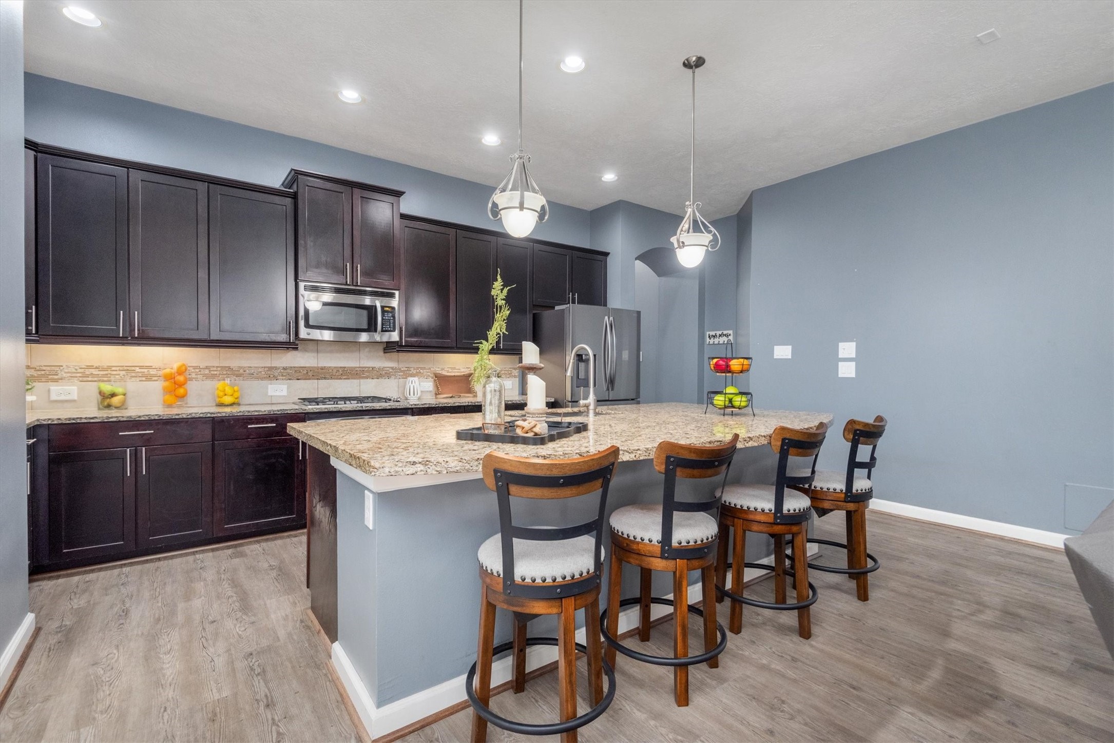 31563 Ember Trail Lane Spring, TX 77386 - Photo 8 of 39 This stunning kitchen is designed for both style and efficiency, featuring an expansive oversized island that serves as the heart of the space—perfect for meal prep, casual dining, and entertaining guests.