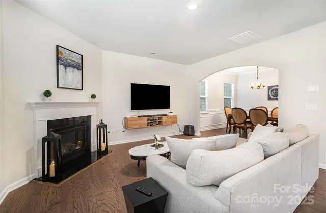 a living room with furniture flat screen tv and a fireplace