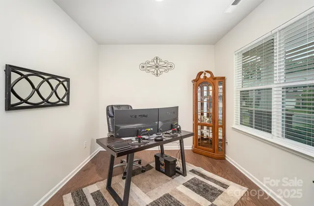 a view of a workspace with furniture and a window