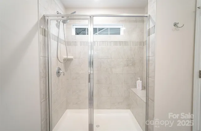 a bathroom with a glass shower door