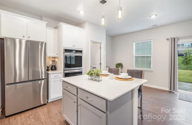 a kitchen with refrigerator and stove