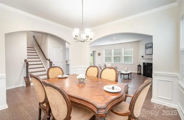 a dining room with furniture and wooden floor