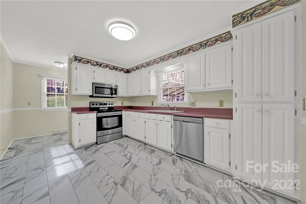 311 Maple Street, Unit 7 Union, SC 29379 - Photo 12 of 34 a kitchen with granite countertop a stove sink and cabinets