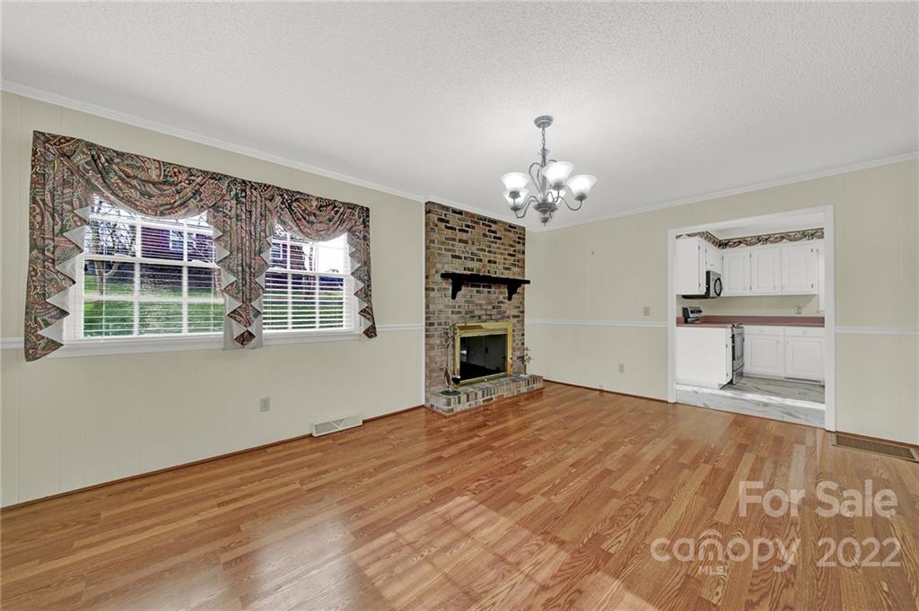 311 Maple Street, Unit 7 Union, SC 29379 - Photo 8 of 34 a view of a room with a chandelier and wooden floor