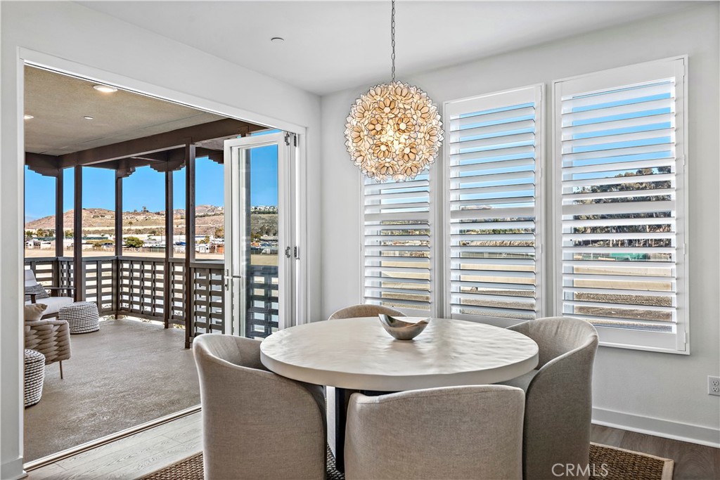 1309 Doheny Way Dana Point, CA 92629 - Photo 14 of 45 a view of a dining room with furniture and large windows
