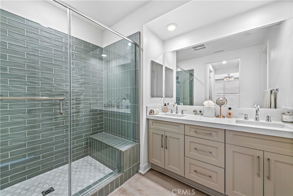 1309 Doheny Way Dana Point, CA 92629 - Photo 25 of 45 a bathroom with a double vanity sink mirror and shower