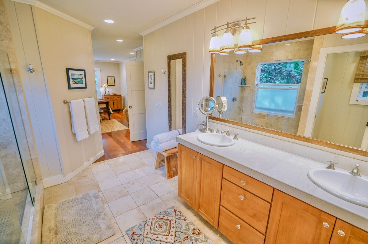 4412 Aku Road Hanalei, HI 96714 - Photo 17 of 30 a spacious bathroom with a granite countertop sink and a mirror