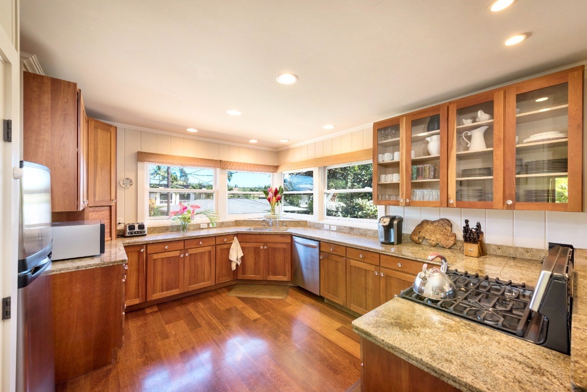 4412 Aku Road Hanalei, HI 96714 - Photo 8 of 30 a large kitchen with stainless steel appliances granite countertop a sink and cabinets