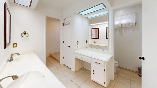 a spacious bathroom with a tub sink and mirror