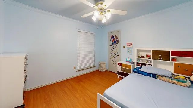 a bedroom with bed and a chandelier