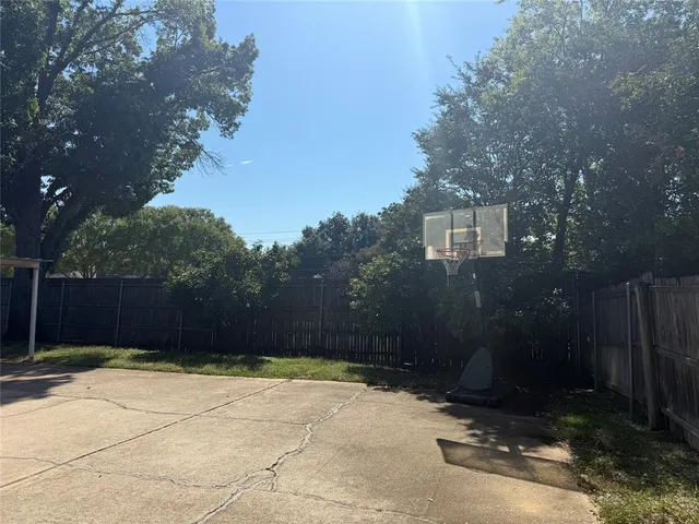 a white bed sitting in a bedroom next to a lamp on a table