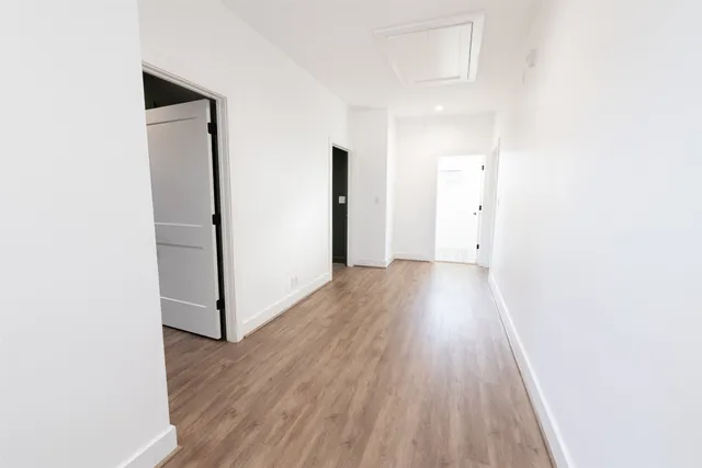 a view of hallway with wooden floor